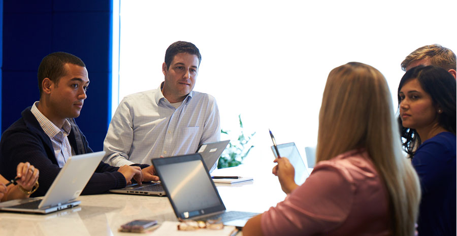 coworkers looking at a computer monitor