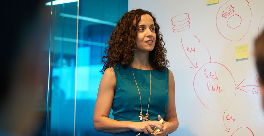 A women explaining about something on white board