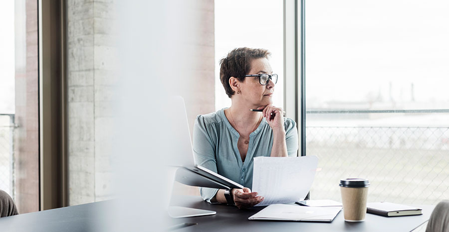  Women taking a window view from her office desk