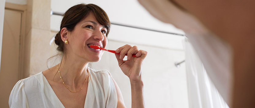 A woman brushing teeth