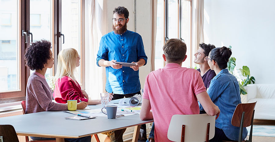 Group of employees gathered in a meeting room for discussion