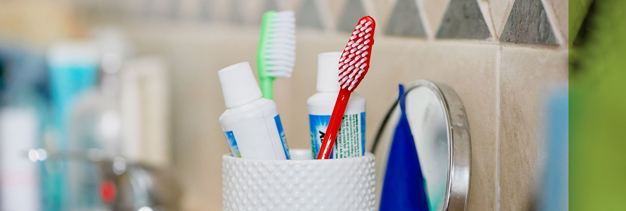 Toothbrushes and toothpaste in a holder