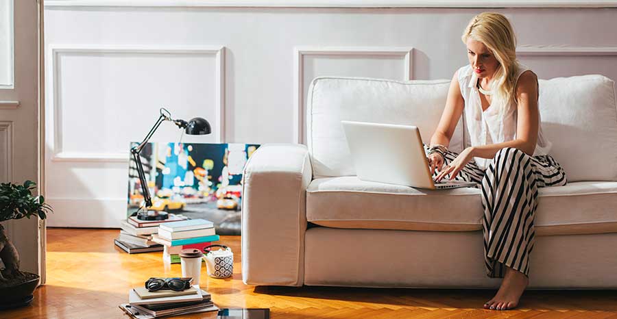 Woman using a laptop on a couch